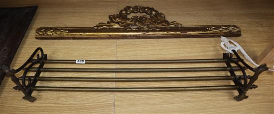 An Italian carved walnut panel, a giltwood frieze and a brass wall rack